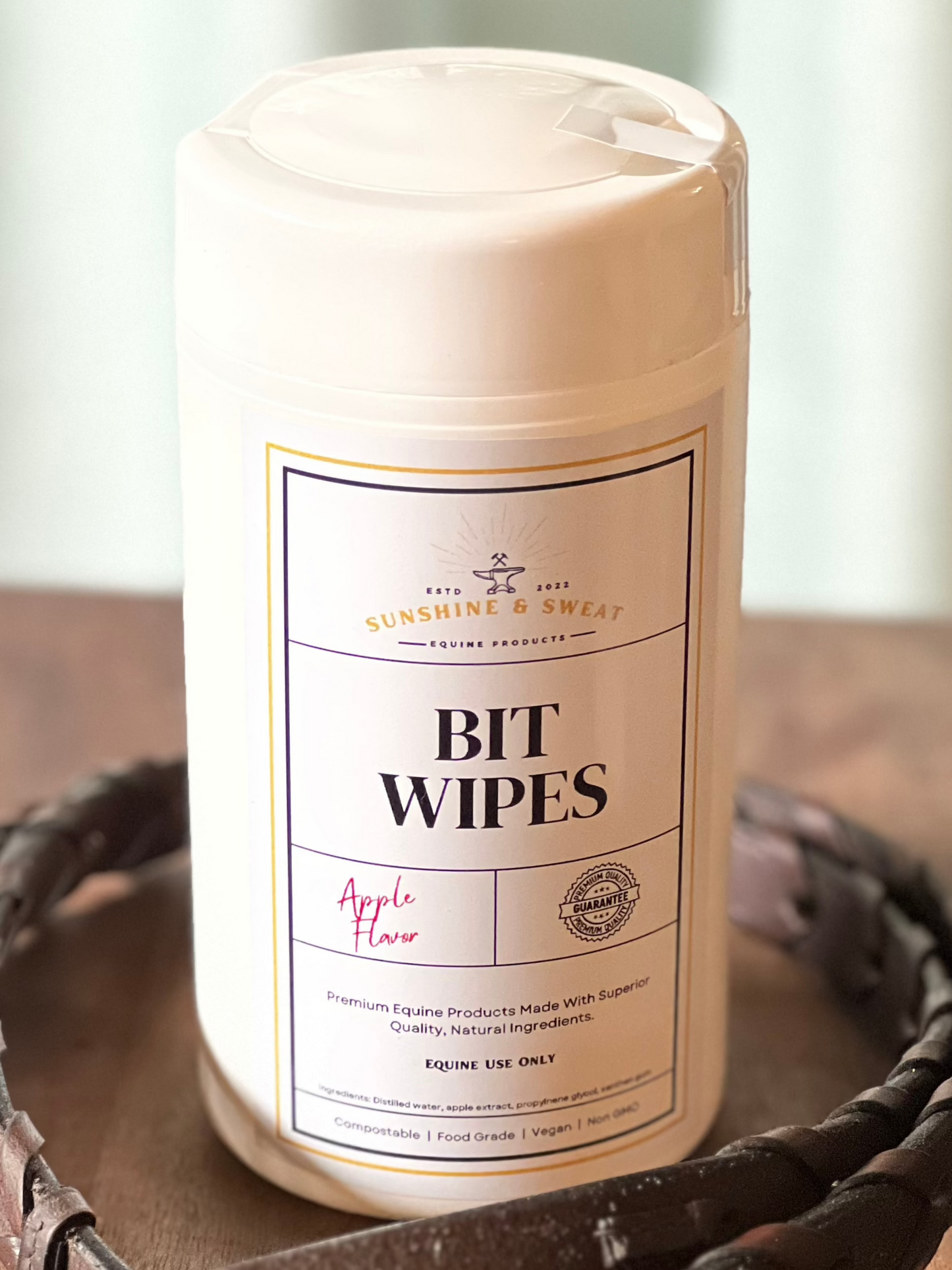 White canister with flip top container with 50 apple flavor bit wipes