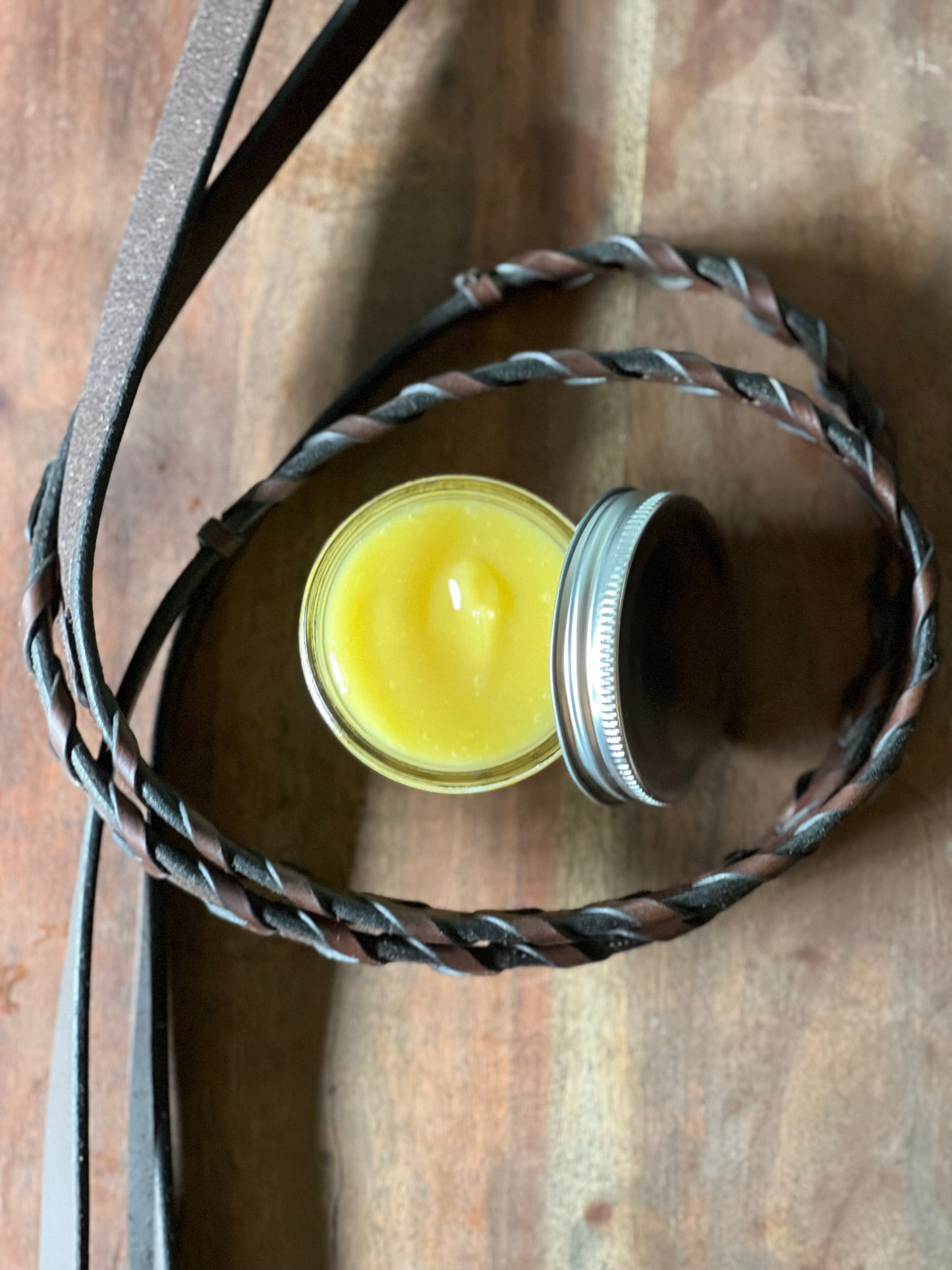 Leather_Balm Yellow balm in clear jar with tin lid