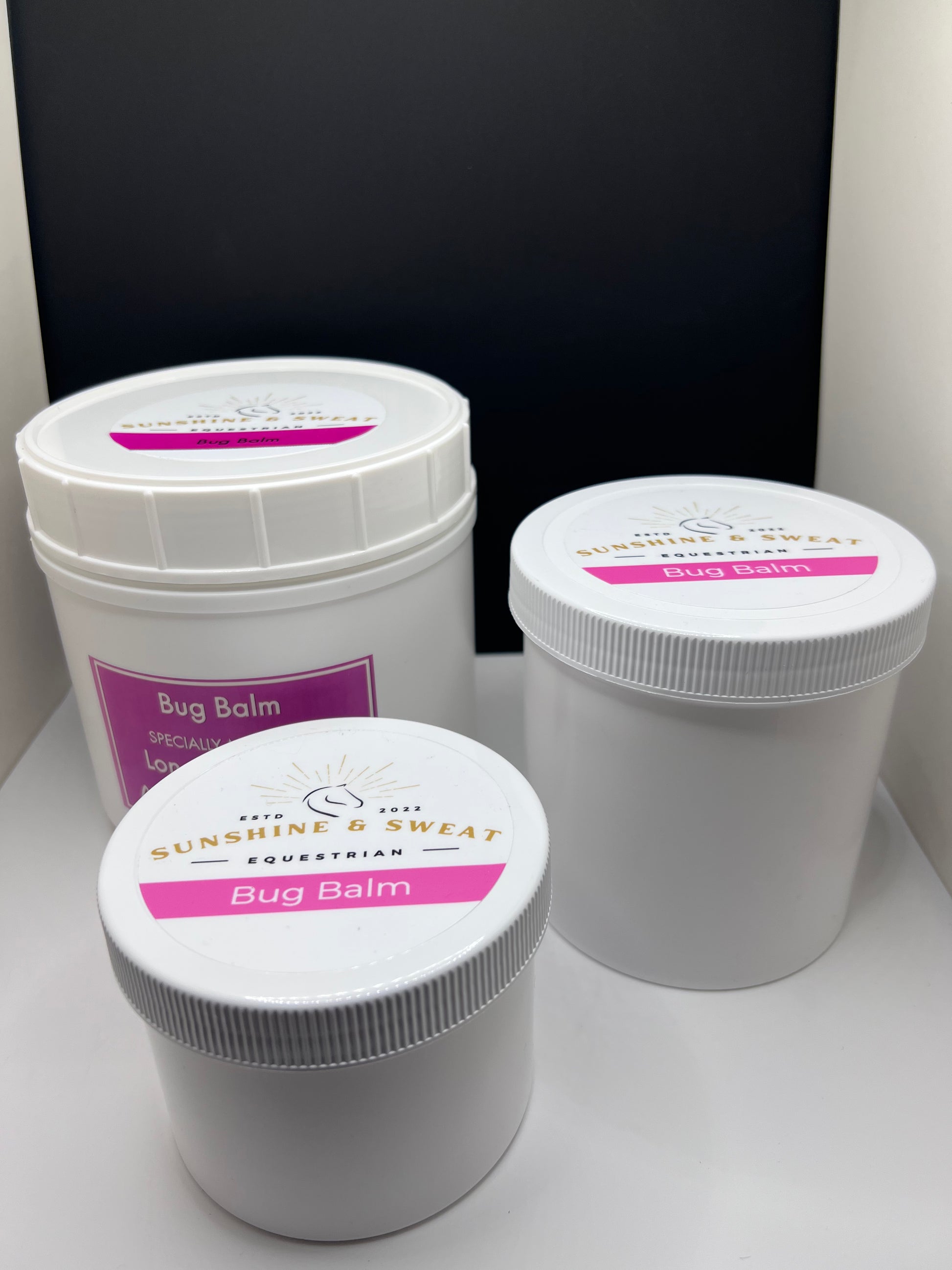 Three different sizes of healing. bug balm in white containers