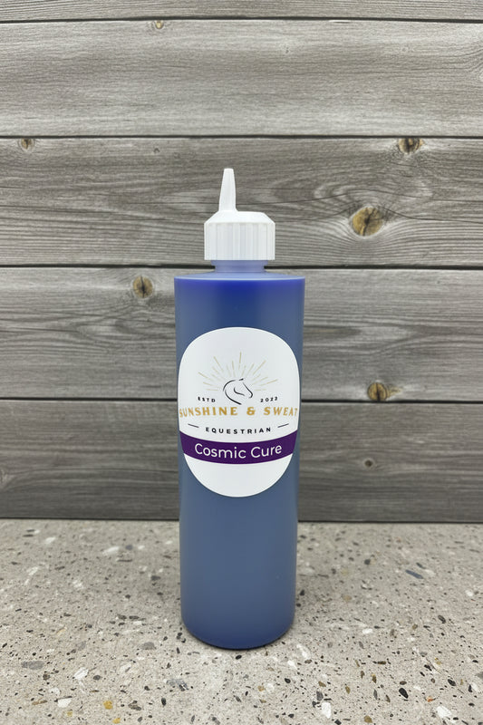 Bottle of 'Cosmic Cure' with a label on a black and white background